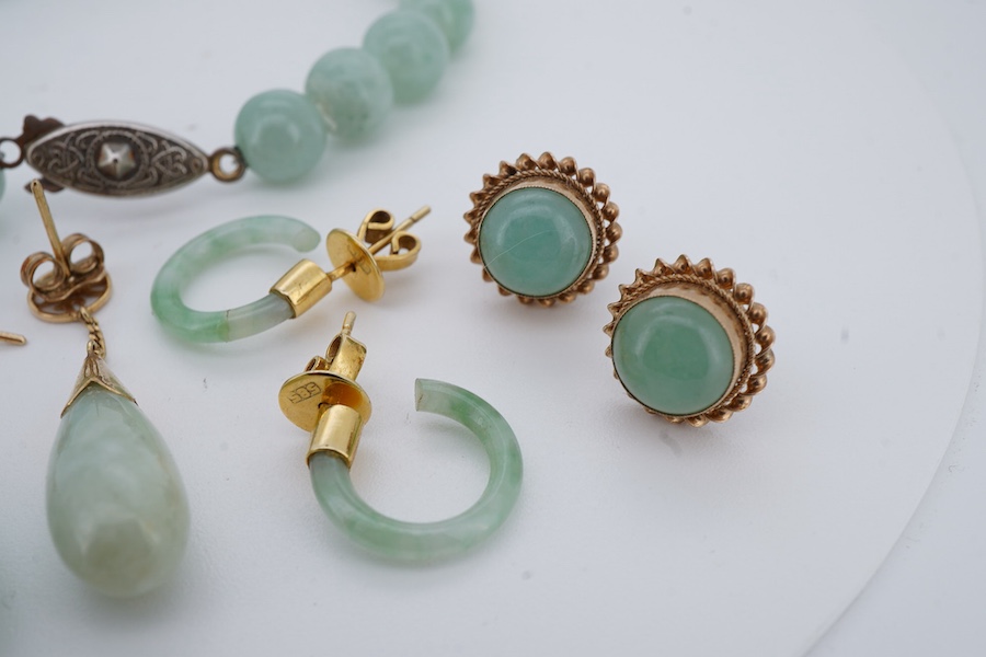 A collection of jadeite jewels, comprising: a bead bracelet with a silver clasp; together with three pairs of studs; one pair of hoop studs, one broken and restuck; and one pair of drop earrings, each set with jadeite, m